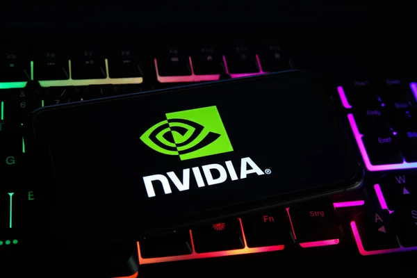 A cell phone on which Nvidia is written is placed on a laptop.
