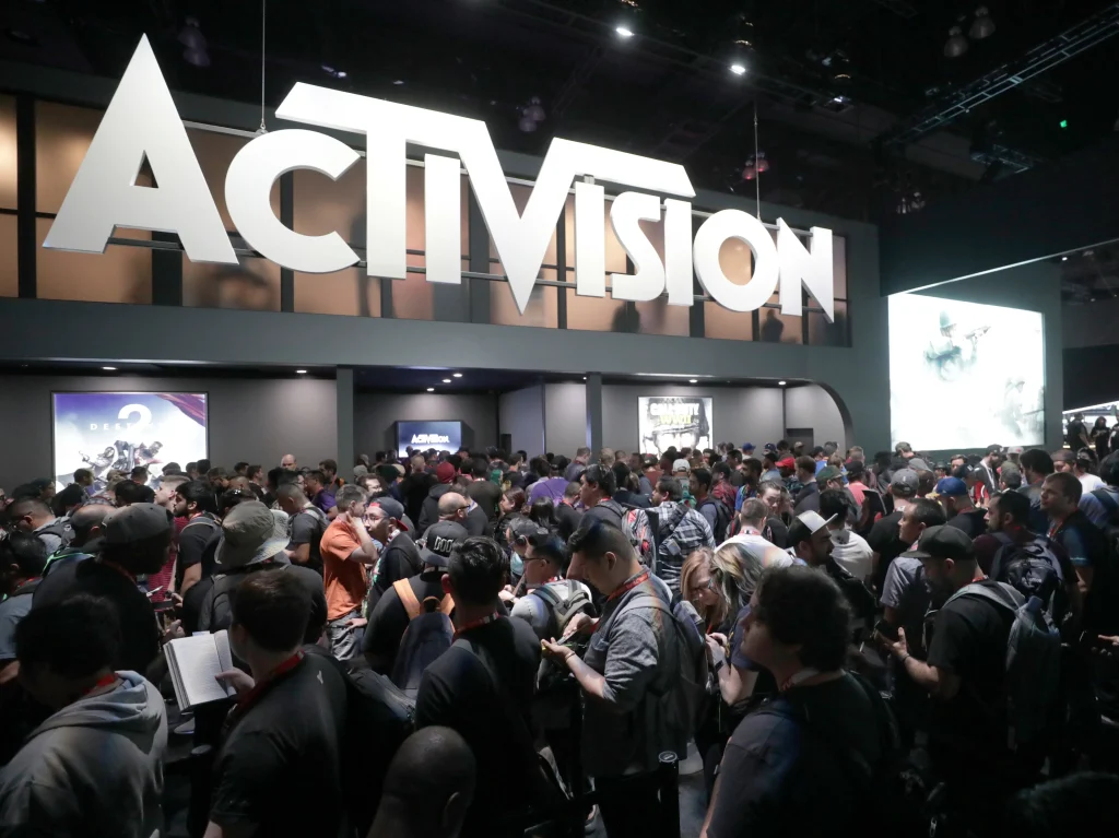Image sowing people standing in front of Activision logo.